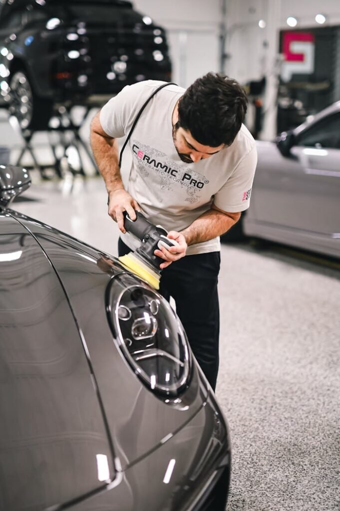 A man polishing a car with a polishing machine